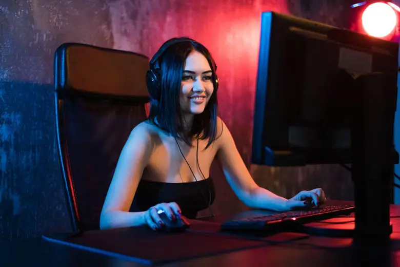 Woman wearing studio headphones when gaming