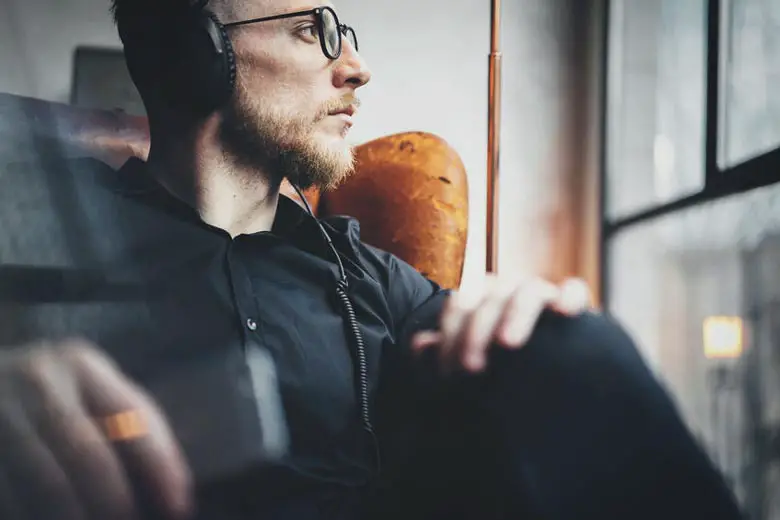 Man listening to music with headphones instead of speakers