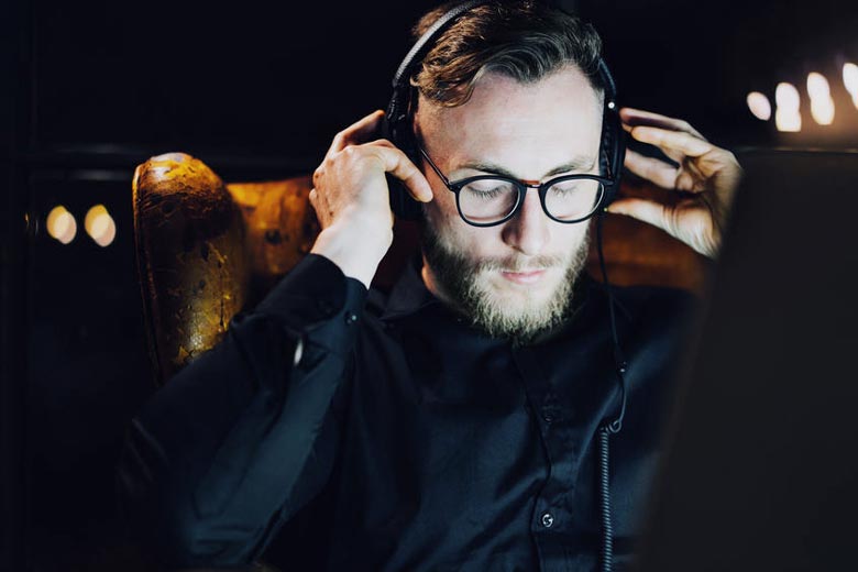 Man with tinnitus listening to headphones