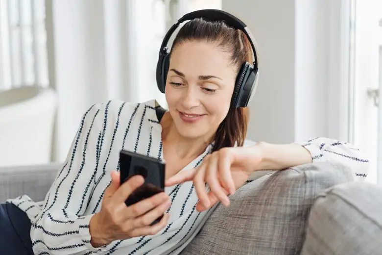 Woman listening with wireless headphones