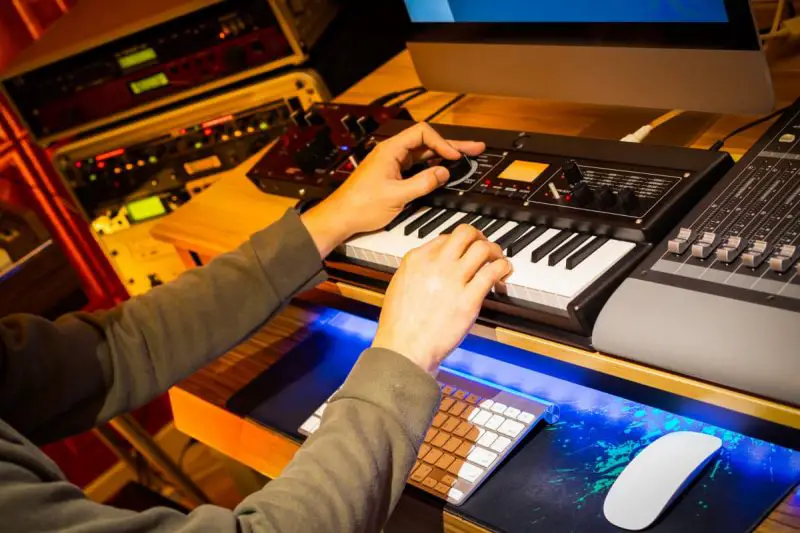 Man using both audio interface and mixer in studio