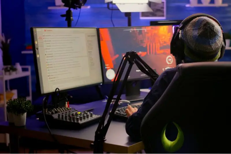 Man using a USB mixer when streaming games 